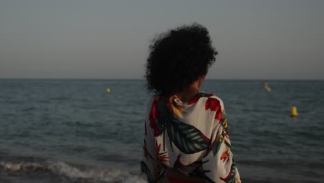 woman on a beach with floral shirt