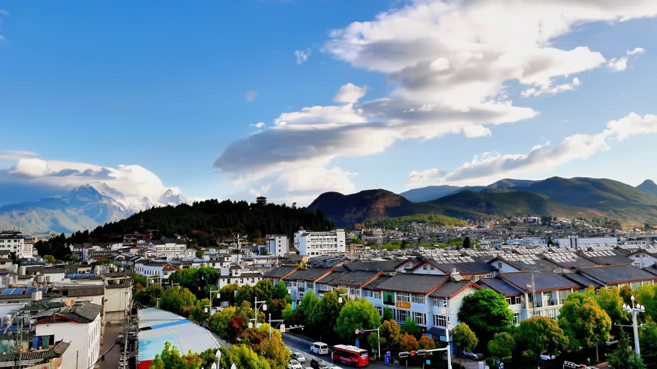 Panoramic View of a Town with Mountains and Cloudy Sky