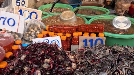 crabs being sold at a bustling market stall