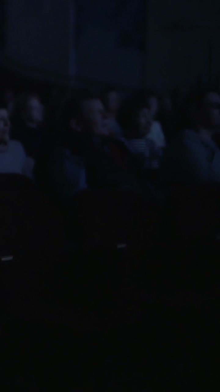Audience in a dimly lit theater