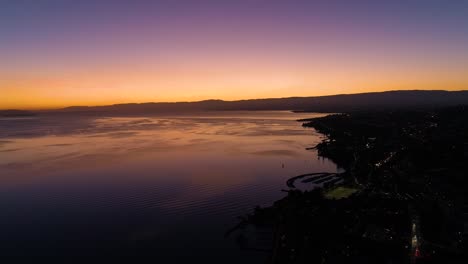 flying high along the coast of lake léman with beautiful sunset colors lutry, vaud - switzerland