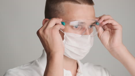 young guy with face mask and protective glasses