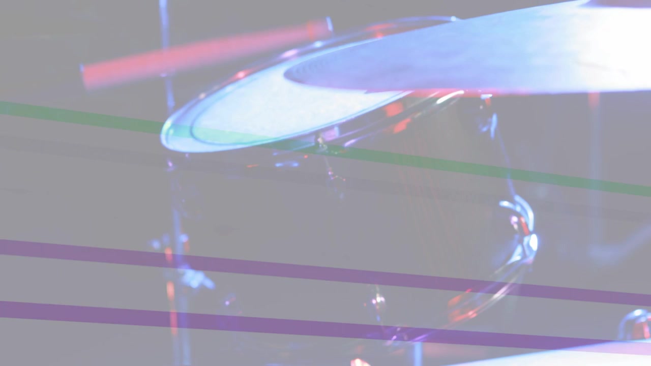 Stage lights sweeping, camera tilting upward right, revealing drum head and tom showing kit layout