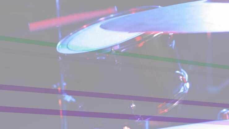 Stage lights sweeping, camera tilting upward right, revealing drum head and tom showing kit layout