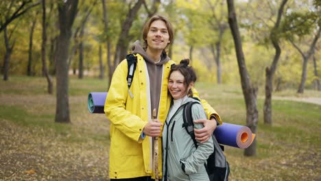 happy couple of active travelers in the forest enjoying outdoor leisure, activity and healthy recreation