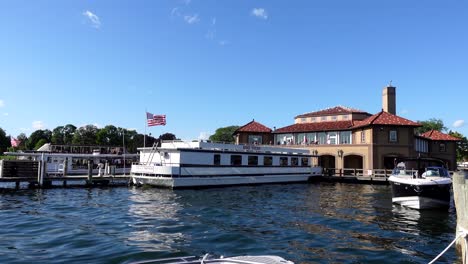 Boat-docked-near-a-pier-and-boat-house-on-a-sunny-summer-day