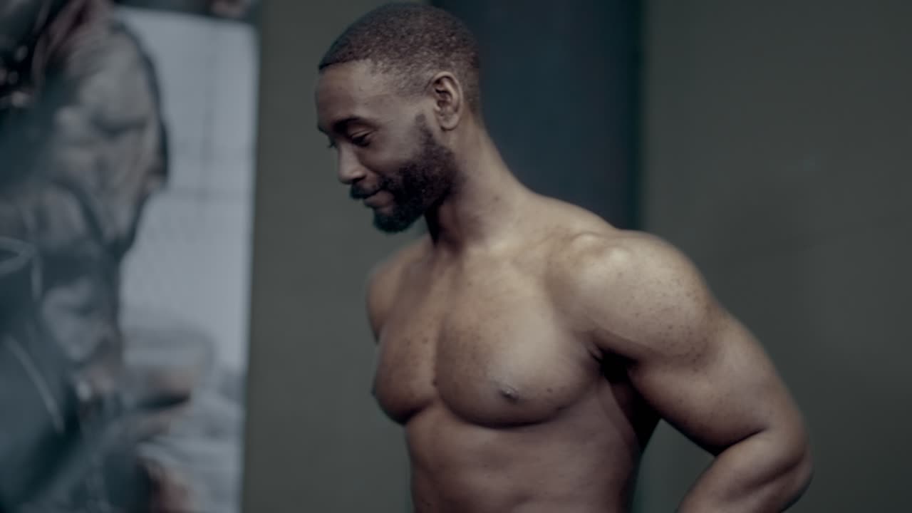 Athletic African American man smiling while warming up for dips