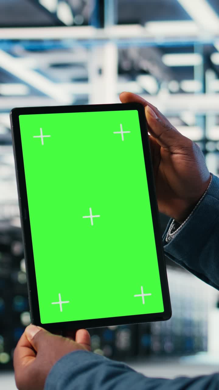 Vertical video Green screen mockup tablet, hardware and worker in server room