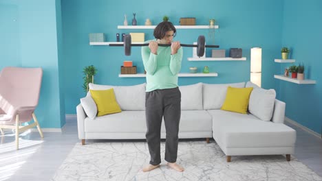 Funny-looking-sportsman-hurting-his-arm-while-lifting-weights-at-home.