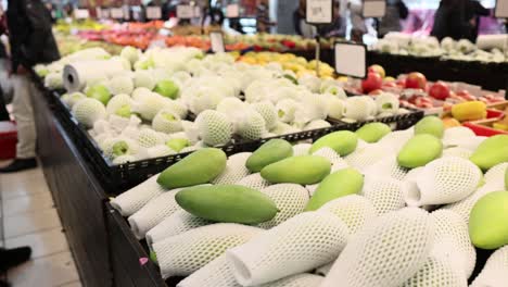 shoppers explore a vibrant fruit market