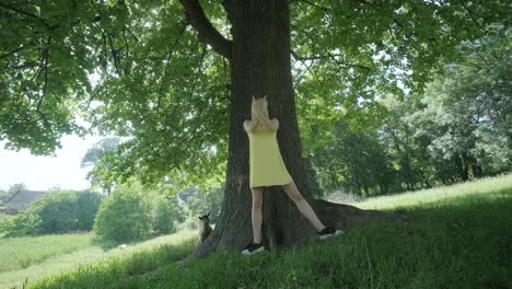 happy beautiful young girl dancing of freedom in summer park with trees in the background.