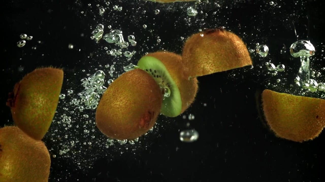 Kiwi Fruit Halves Splashing into Water in Slow Motion