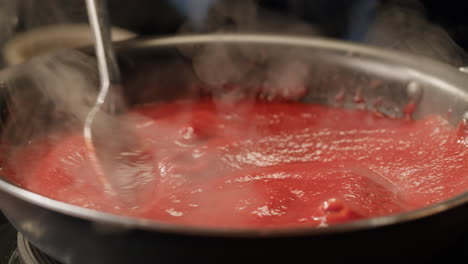 cooking red sauce in a pan