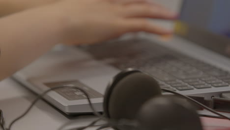 person working on a laptop with headphones