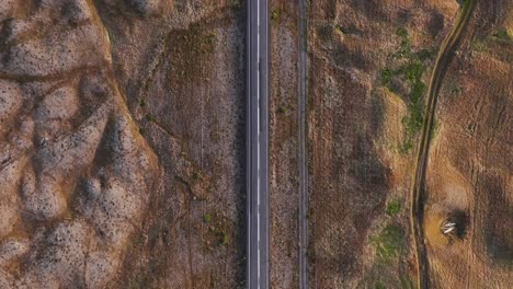 ring road hringvegur seen from above with rolling volcanic terrain in iceland, car passing by