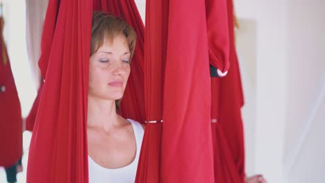 relaxed-lady-enjoys-sitting-in-hammock-and-restores-energy