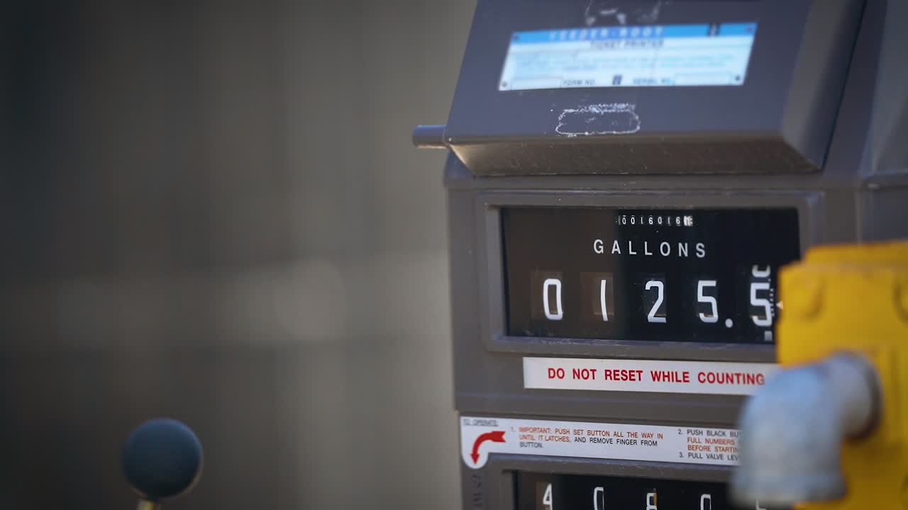 Counting gallons of gas at truck stop in slow motion