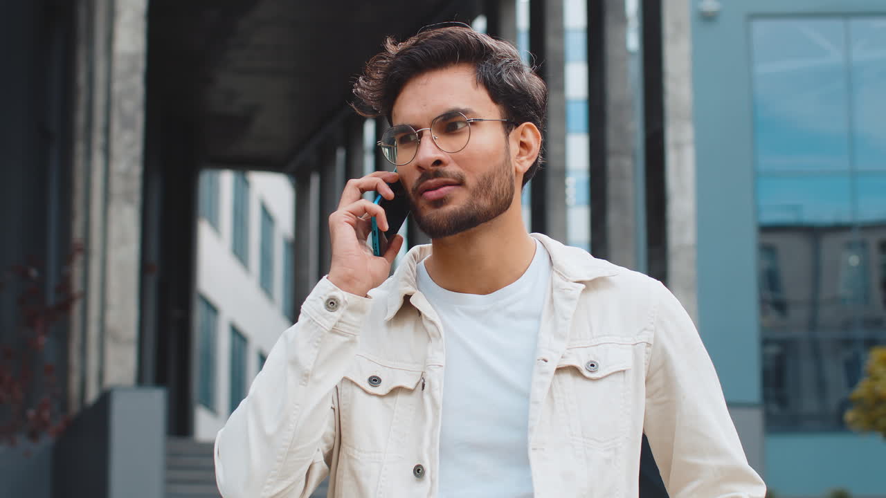 Happy surprised indian man involved in pleasant conversation phone call good news enjoying talking