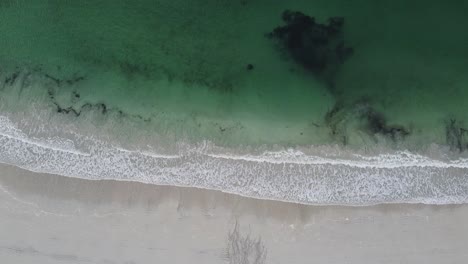 Top-Down-Drone-View-of-Waves-Coming-on-Beach-in-Lofoten-Norway