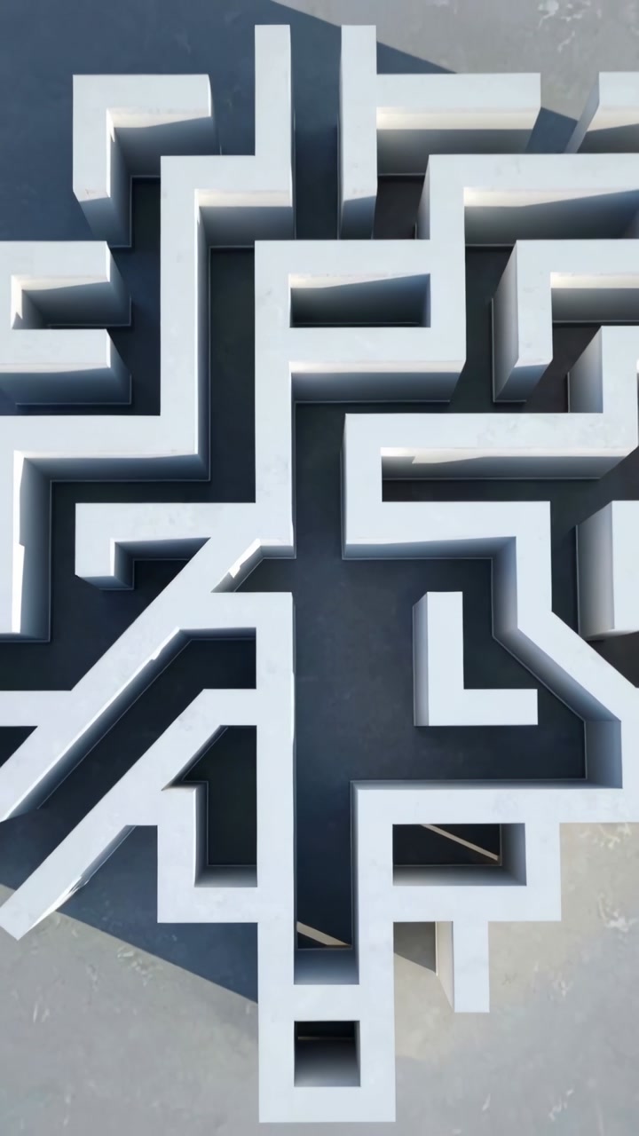 Vertical video: Pulling back camera revealing raised white maze on gray concrete, casting shadows
