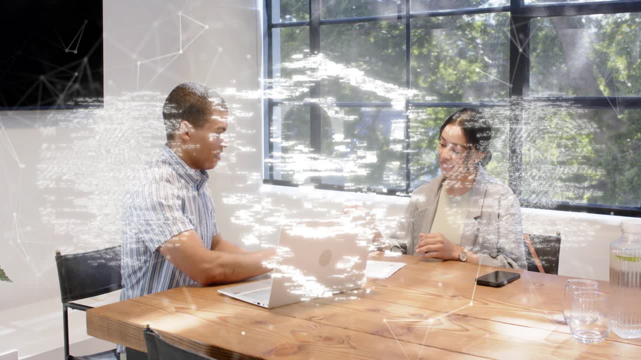 Man passing pen to woman in business meeting causing fingerprint and shield overlay securing deal