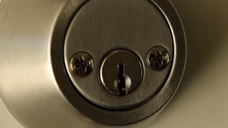 key inserted into deadbolt door lock and turned to right and removed residential medium close