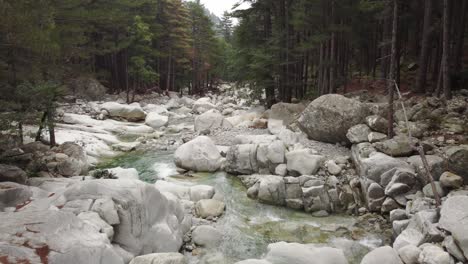 low aerial shot of wonderful river stream with waterfalls in restonica valley