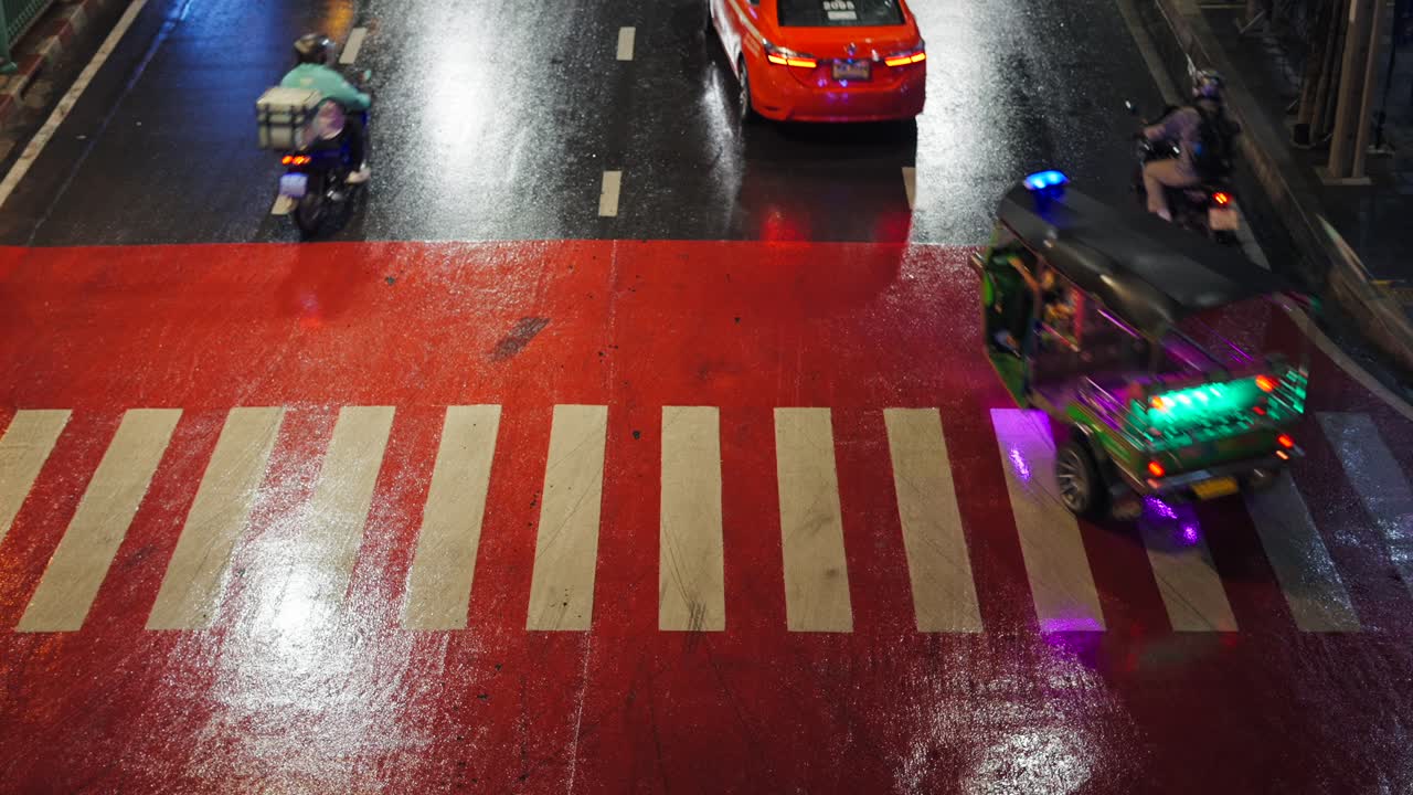 Night Traffic on a Wet City Street with Pedestrian Crossing
