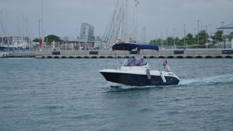 small motorboat navigating a busy port