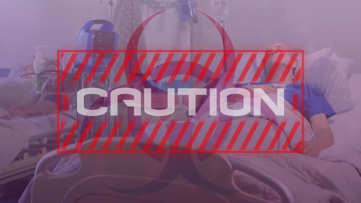 Word Caution written in red frame over a senior male patient. Covid-19 spreading