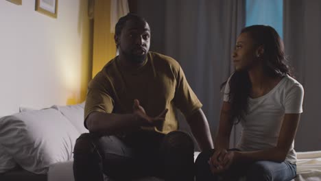 Couple-At-Home-Sitting-On-Bed-At-Night-Having-Argument-6