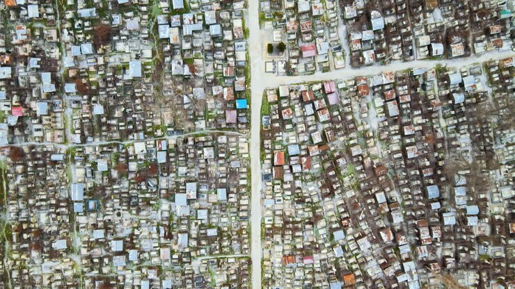 Aerial drone view of a cemetery in Chisinau, Moldova. Multiple graves, crypts, walkway, Cloudy weather, bare trees, winter
