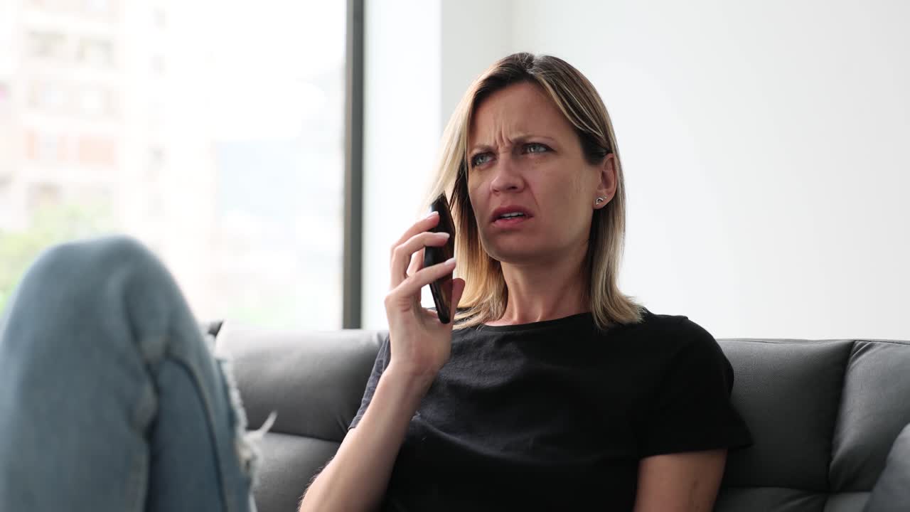 Woman screams in shock while looking at her phone