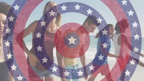 Animation-of-american-flag-circles-spinning-over-friends-walking-on-beach
