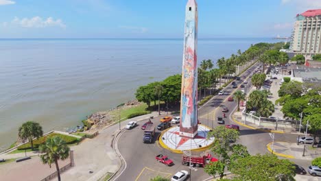 aerial view of colorful obelisk monument by the ocean in coastal city