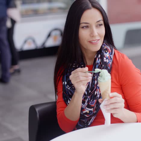 Woman-eating-an-ice-cream-in-a-parlor-or-cafe