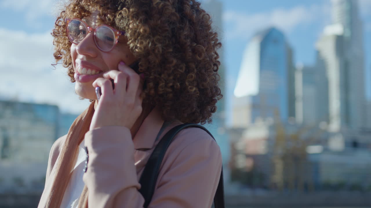Cheerful Black Businesswoman Calling on Phone Outdoors