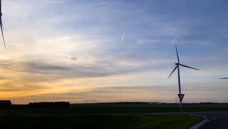 Rotating-wind-turbines-at-sunset