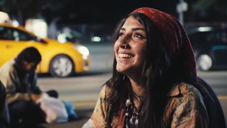 a joyful moment captured: a young woman smiling under city lights with a red scarf, exuding happiness and connection in a vibrant urban atmosphere