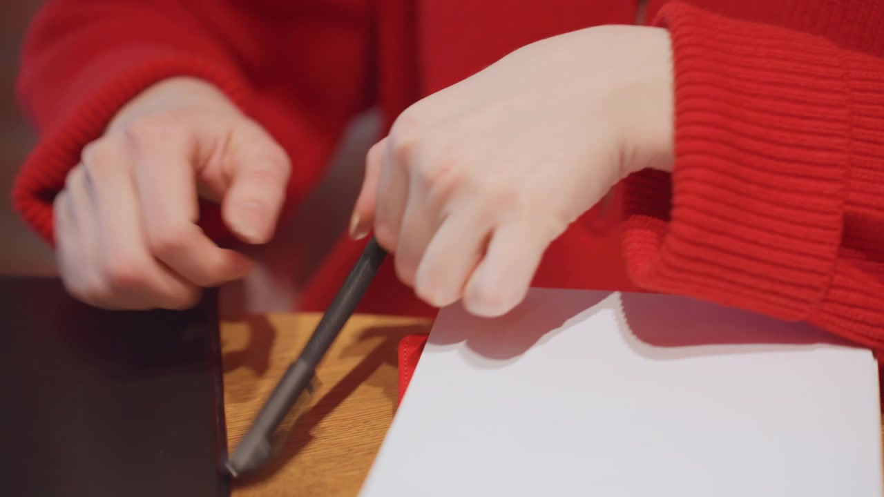 Close-up of Woman's Hands Unpacking Pen and Notebook
