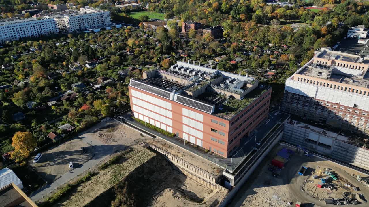 biggest data center building providing cloud computing services in an urban city. blockchain digital database, internet security for sensitive data. Magic aerial view flight panorama orbit drone