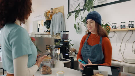customer paying with contactless payment in a cafe