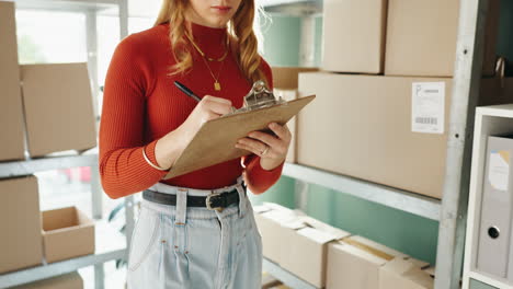woman checking inventory in warehouse
