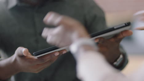 close up african american engineers developing engine turbine prototype using digital tablet computer sharing 3d design ideas on screen brainstorming mechanical project in office presentation meeting