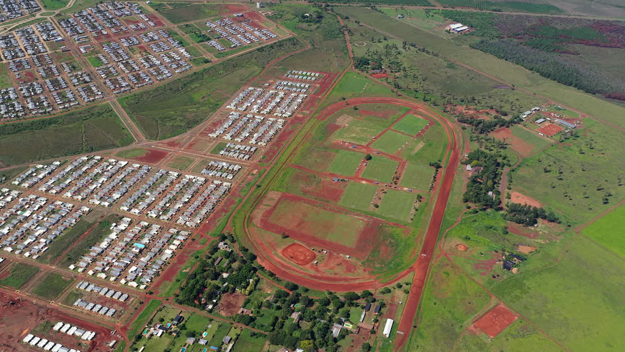 Aerial view of Posadas Hippodrome in Argentina showing oval track, sports fields and surrounding residential area
