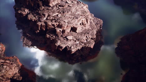 aerial view of a canyon with water reflecting the sky