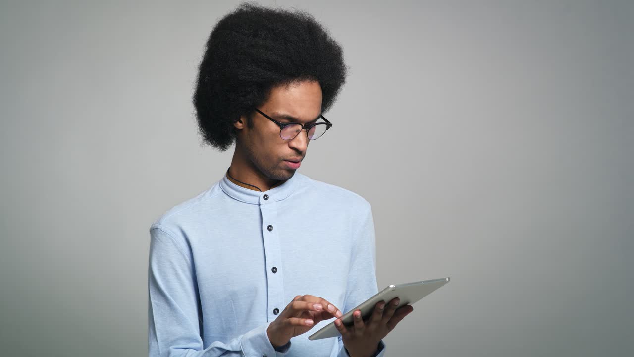 Young African man uses a digital tablet