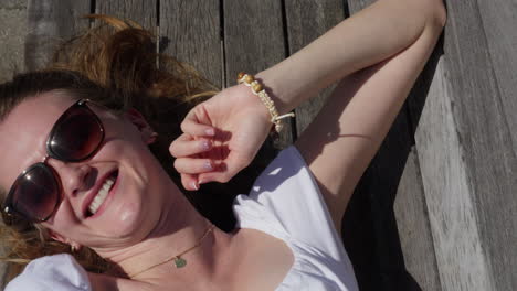 young lady is laughing on a bench