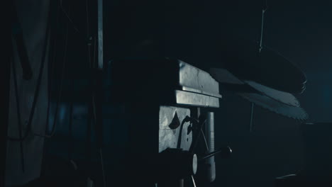 mysterious man in the workshop at night smokes a cigarette