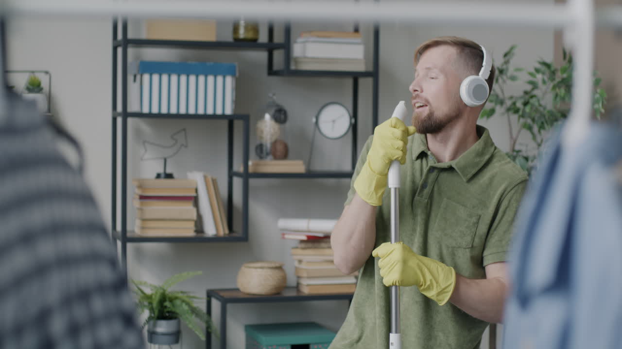 Man Cleaning His Home While Listening to Music